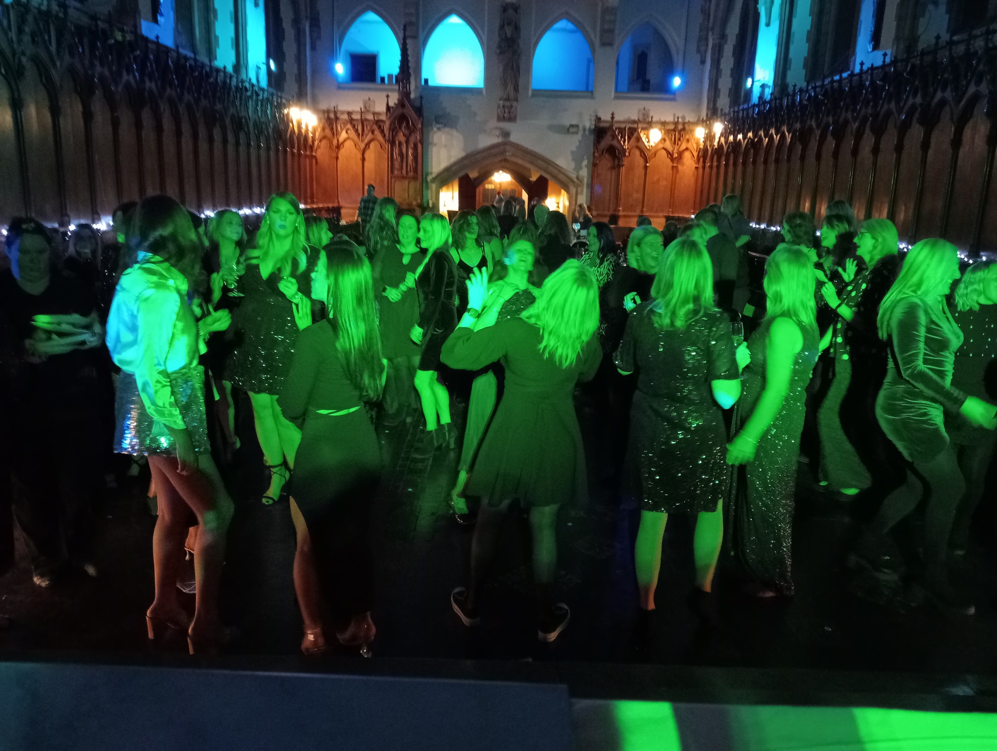 A vibrant party crowd with hands in the air